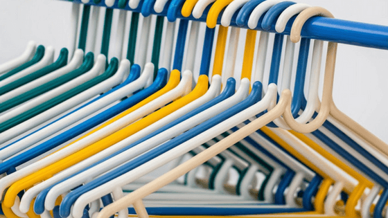 Coordinated hangers make a small walk-in closet look good.