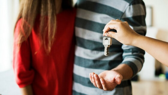 Gracious host giving house guests a key.